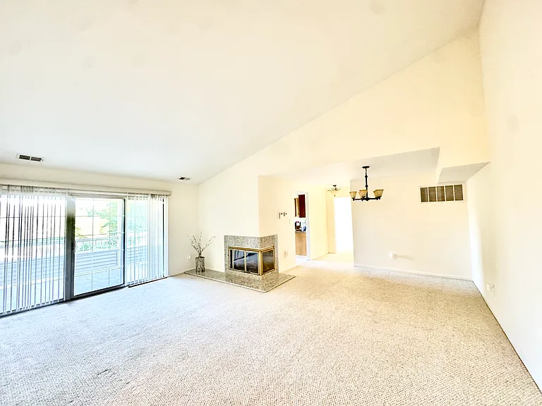 Sunny living area is accented with soaring cathedral ceilings