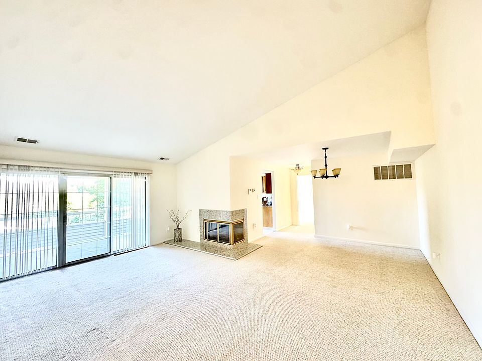 Sunny living area is accented with soaring cathedral ceilings