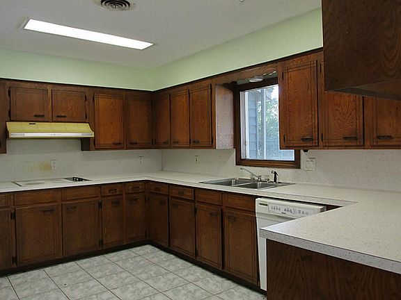 KITCHEN HAS LOTS OF CABINETS AND COUNTER SPACE, NEW TILE FLOOR, NEW HOT WATER HEATER TOO