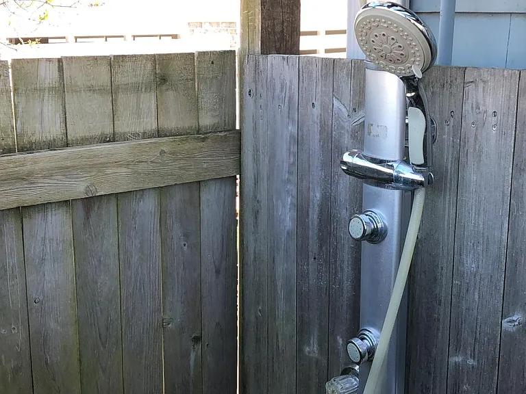 Seasonal hot and cold water outdoor shower with body jets, rain shower, and hand sprayer, as well as foot wash for after the beach or summer sports.