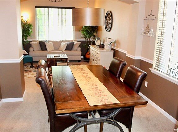 Ample formal dining room with chair-rail molding and new light fixture.