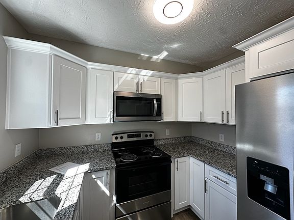 Plenty of cabinet and counter space plus refrigerator with ice/water dispenser, range and microwave vented to outside.