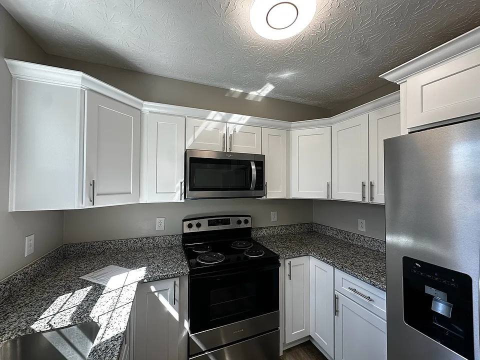 Plenty of cabinet and counter space plus refrigerator with ice/water dispenser, range and microwave vented to outside.