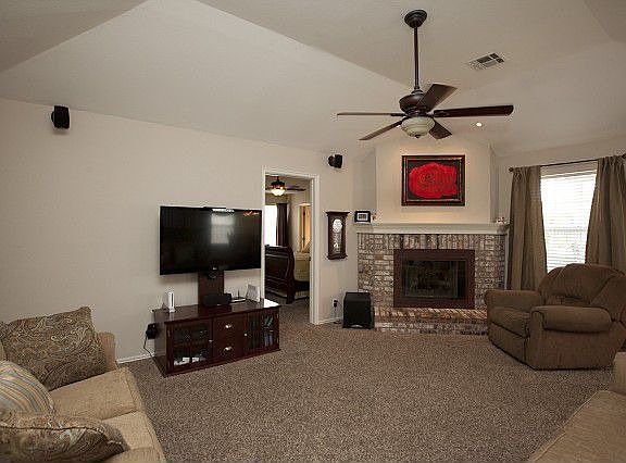 Living room has fireplace and vaulted ceilings