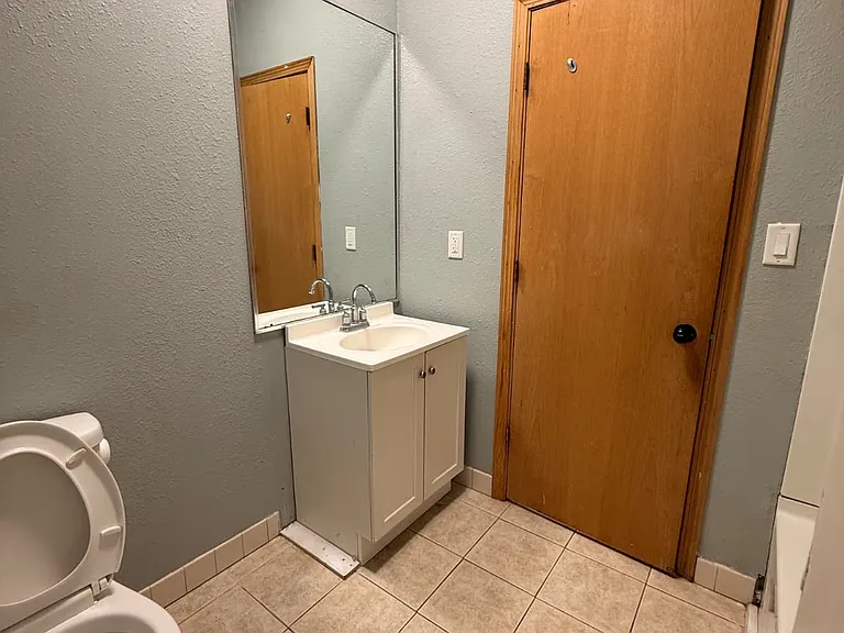 Bathroom entry, bathtub on the side