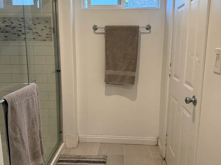 Bright bathroom with oversized glass-enclosed shower