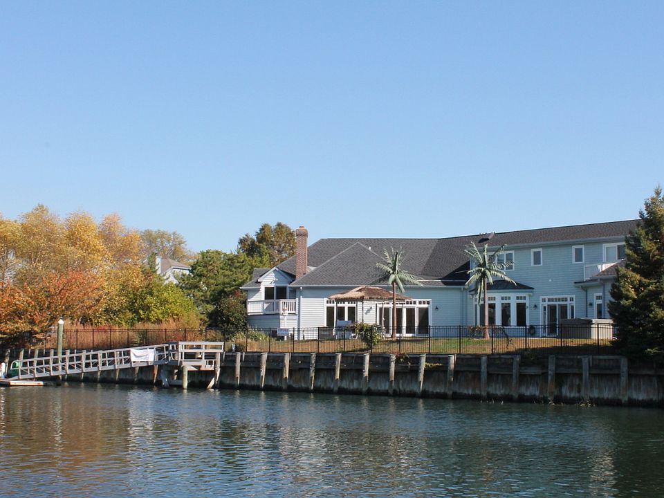 Rear of home with dock.
