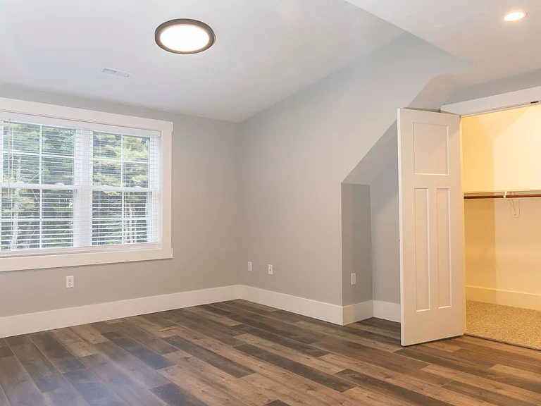 Spacious bedroom with custom walk-in closet.