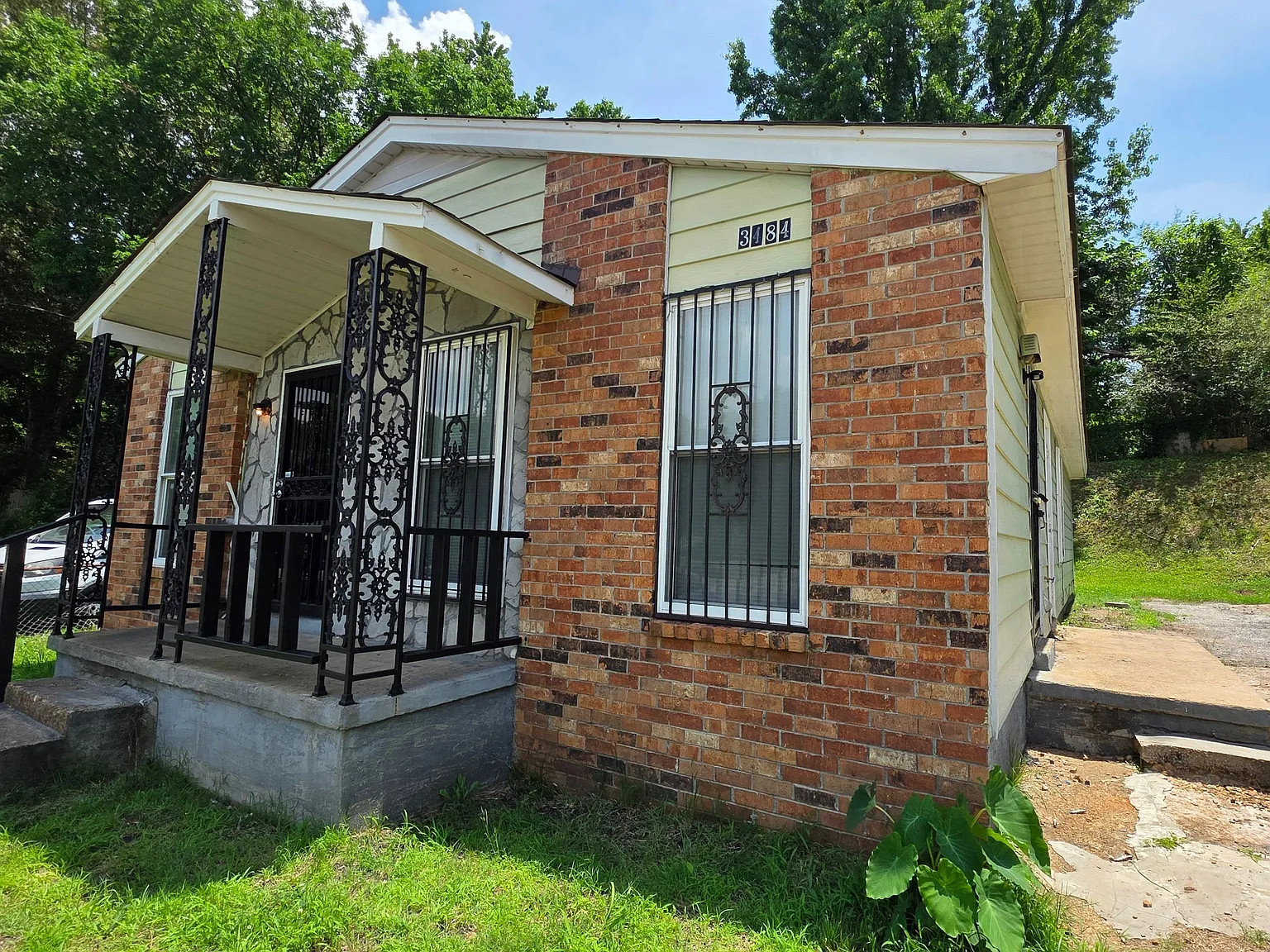Cozy 4-Bedroom Brick Home with Front Porch Charm — Photo 2