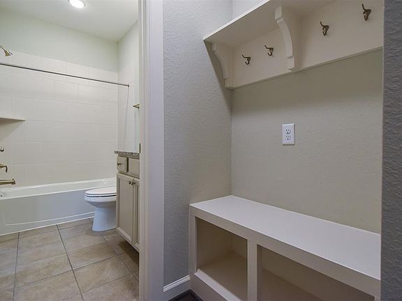 Spacious mud room and full bath.