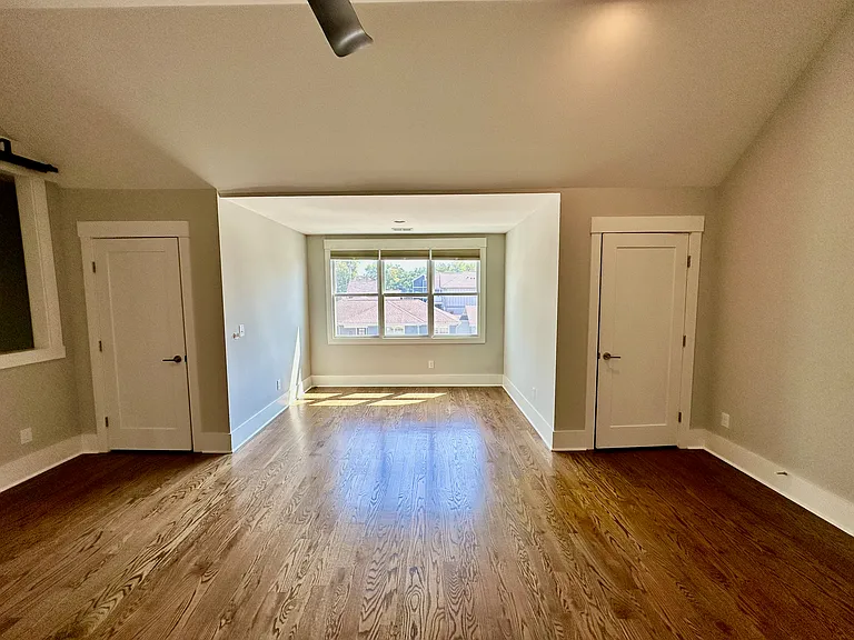 The space near the windows is large enough to fit a Queen Bed along with a desk and chair