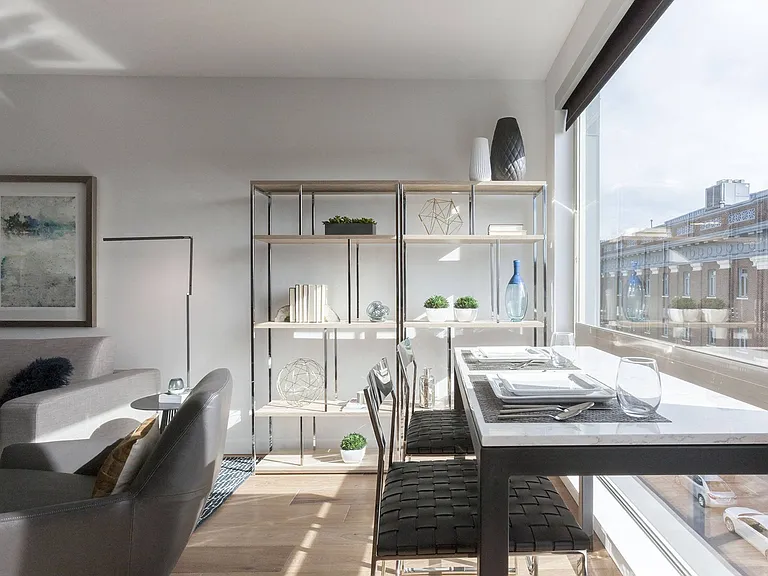 Living Room with Wall Shelving, Dining Table, and Large Window