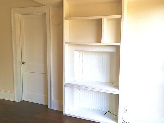 Living room includes custom built in shelving