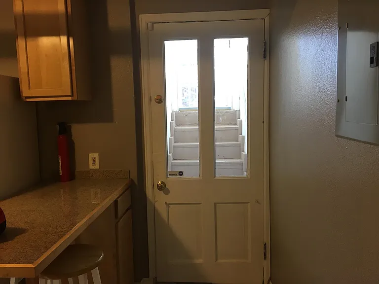 Private entrance from kitchen to back yard -- security door