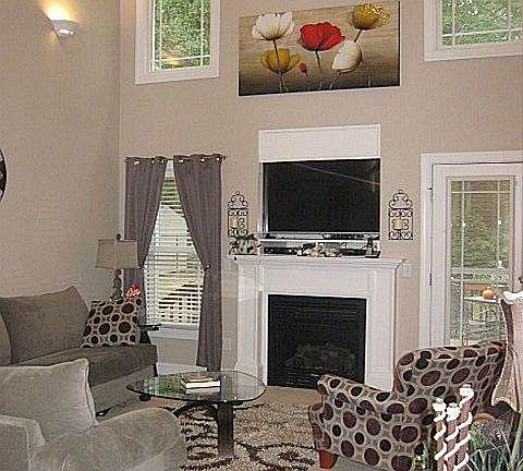 Stunning 2-story living room with cozy gas-log fireplace for those chilly fall and winter evenings!