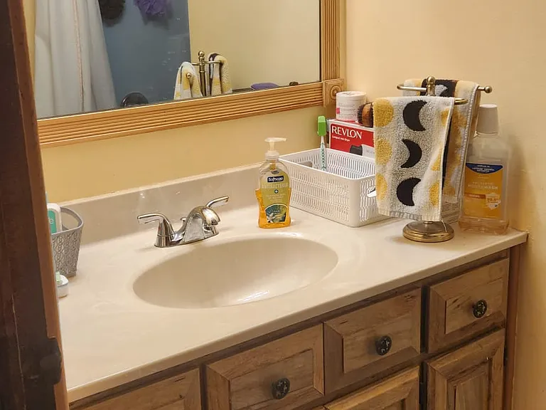 Shared bathroom view of shower via mirrow
