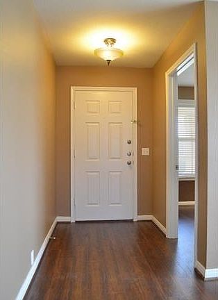 Separate study with glass door, tract lighting, windows, chair railing and custom paint just off of 