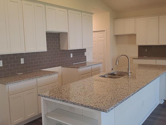 Kitchen with granite and backsplash