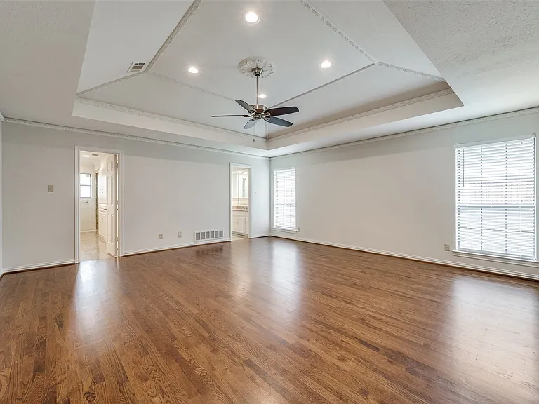 Primary bedroom with entrances to separate his and hers bath areas