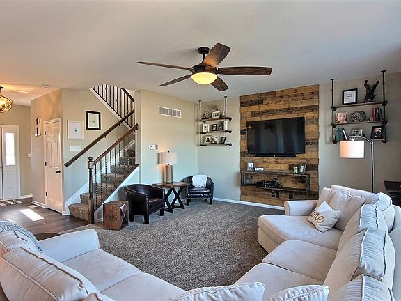 GREAT ROOM WITH DECORATIVE SHELVING AND SHIPLAP...NOTICE THE UPGRADED RAILINGS
