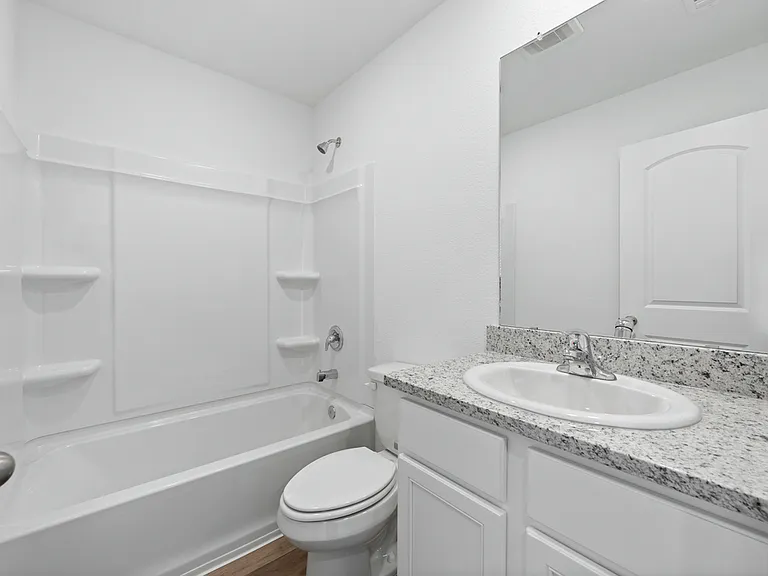 The second bathroom with granite countertops.