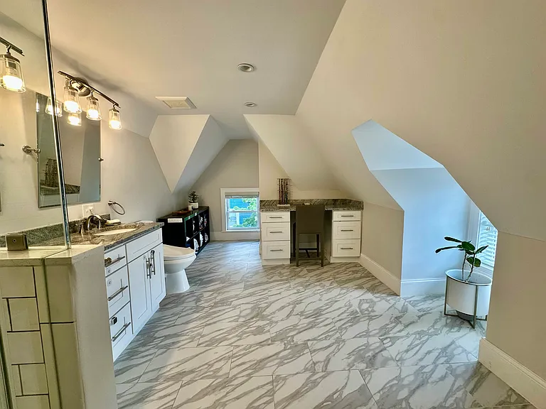 Large updated primary bathroom with double vanity, modern finishes, and excellent natural light.