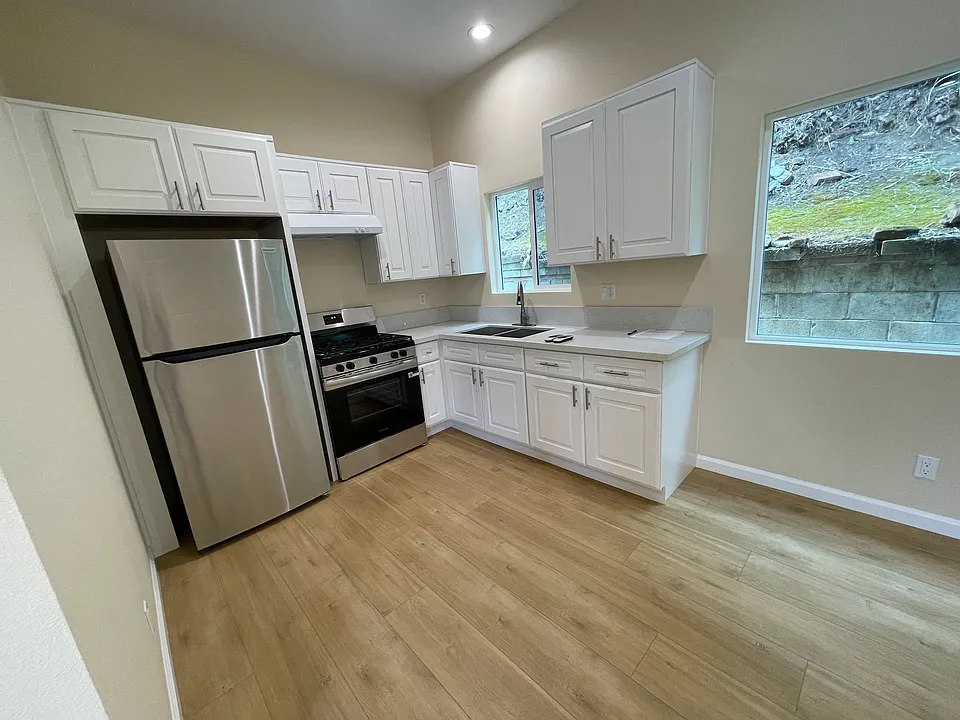 Full kitchen with plenty of cabinet space and brand new stainless steel major appliances