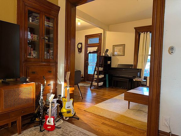 View from dining room into living room/front entry.
