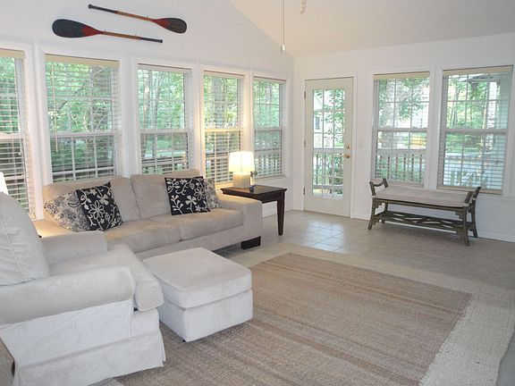 Large sunroom surrounded by back deck