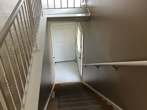 Private stairway from entryway. The two doors on t