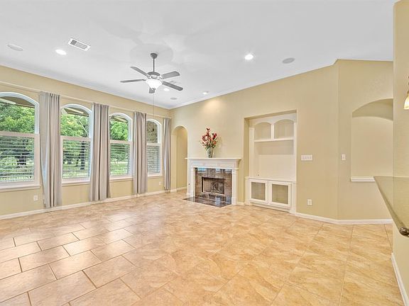 Large family room with wall of windows overlooking the country garden and neighborhood lake.