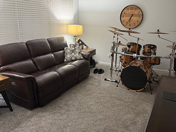 Living Room with full-length front windows with decorator wood blinds, bringing in loads of natural lighting.