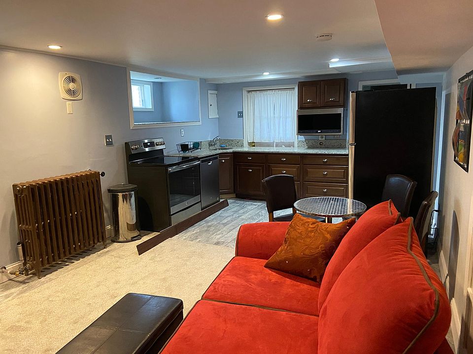 Living kitchen room area full size stove microwave refrigerator