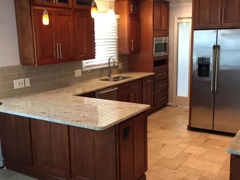 Granite counter tops, tile backsplash and pot filler over stove