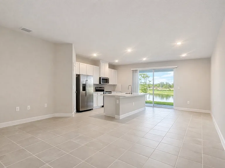 living room/dining room direction to see the kitchen and backyard