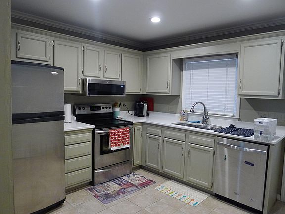 Updated Kitchen with Tiled floor, Stainless Appliances, Quartz Countertops and updated faucets