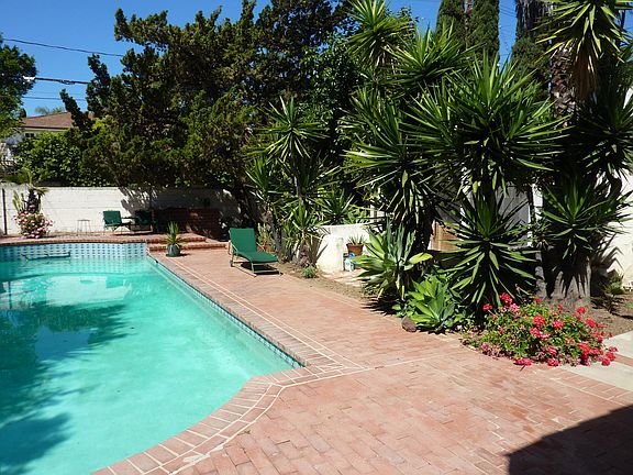 Plants provide privacy on your own front patio, behind the trees.