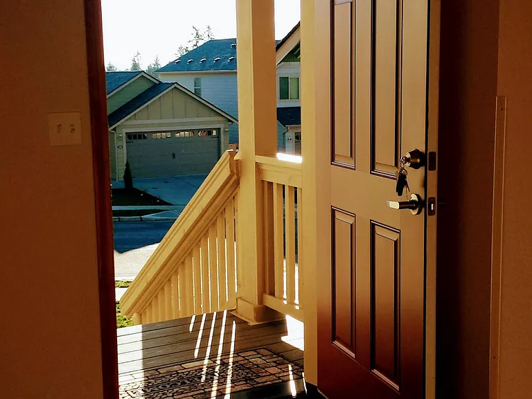 Covered front porch, deadbolt lock, hardwood floor entry. Southern exposure.
