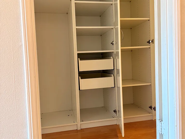 Generous built-in hallway storage with adjustable shelving and drawers