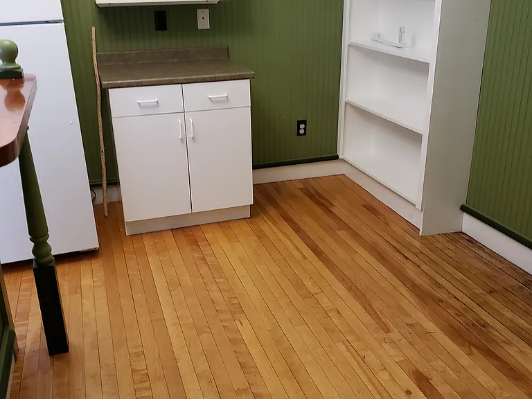 Taken from the hallway to the dining area. (Not room for a large table - this is only a two bedroom apartment after all.) Refrigerator on the left.