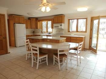 A chef's delight in this large kitchen with heated tile flooring, two tier island, corian and firmica counters.  The garbage disposal was new in 2012.