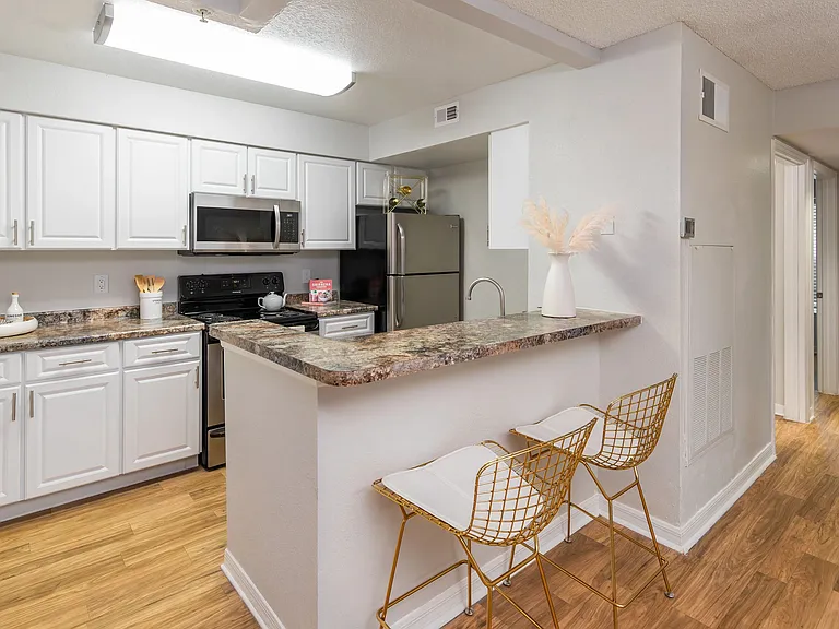 Enjoy a clean, modern kitchen featuring stainless steel appliances, ample cabinet space, and a cozy breakfast bar.