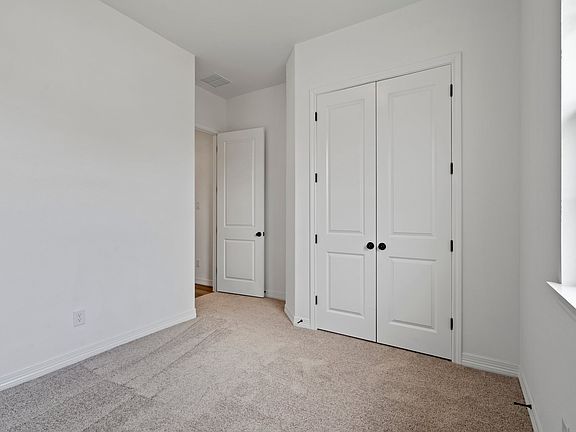 An additional view of the second bedroom and closet.