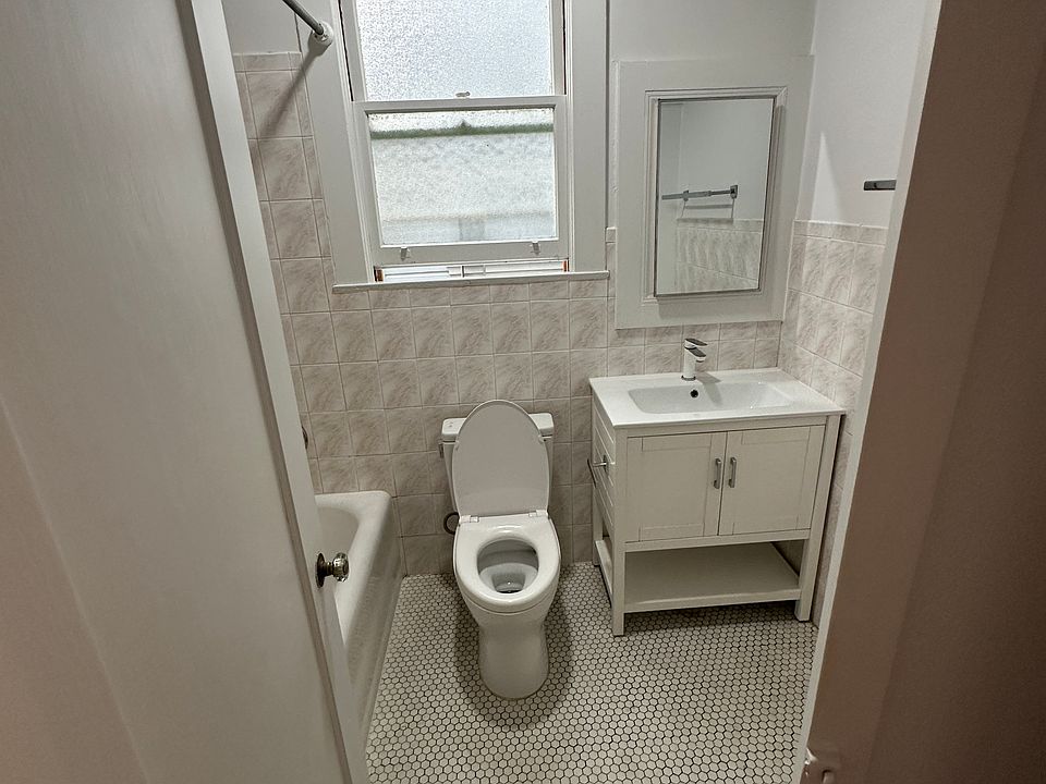 Bathroom , toilet, sink and small cubby behind mirror