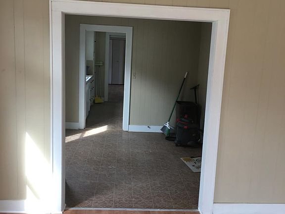Living room with view through dining room and kitchen