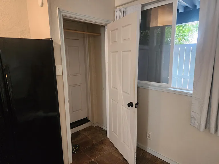 Clothes closet with two levels of rack hangers.