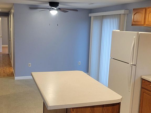 Eat in Kitchen view with hallway to the bedrooms. Living Room is off to the left