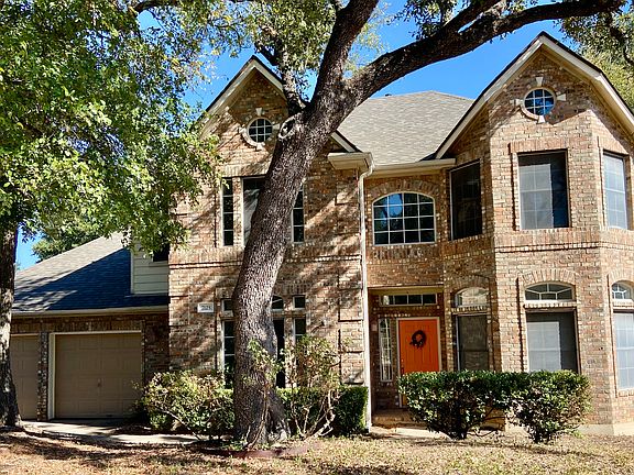View of facade and two-car garage. Check out the ACME brickwork, coins on the side, and soldier coursework dividing the downstairs and upstairs portions. New roof too.
