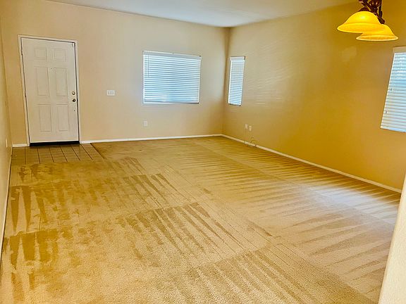 Formal living room and dining area, filled with abundant natural light.