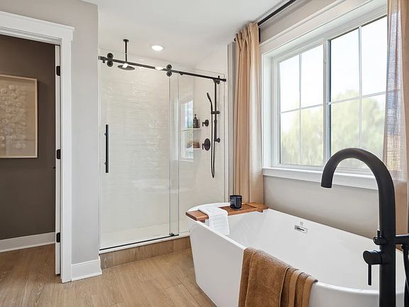 Soaker tub and glass shower in primary bath